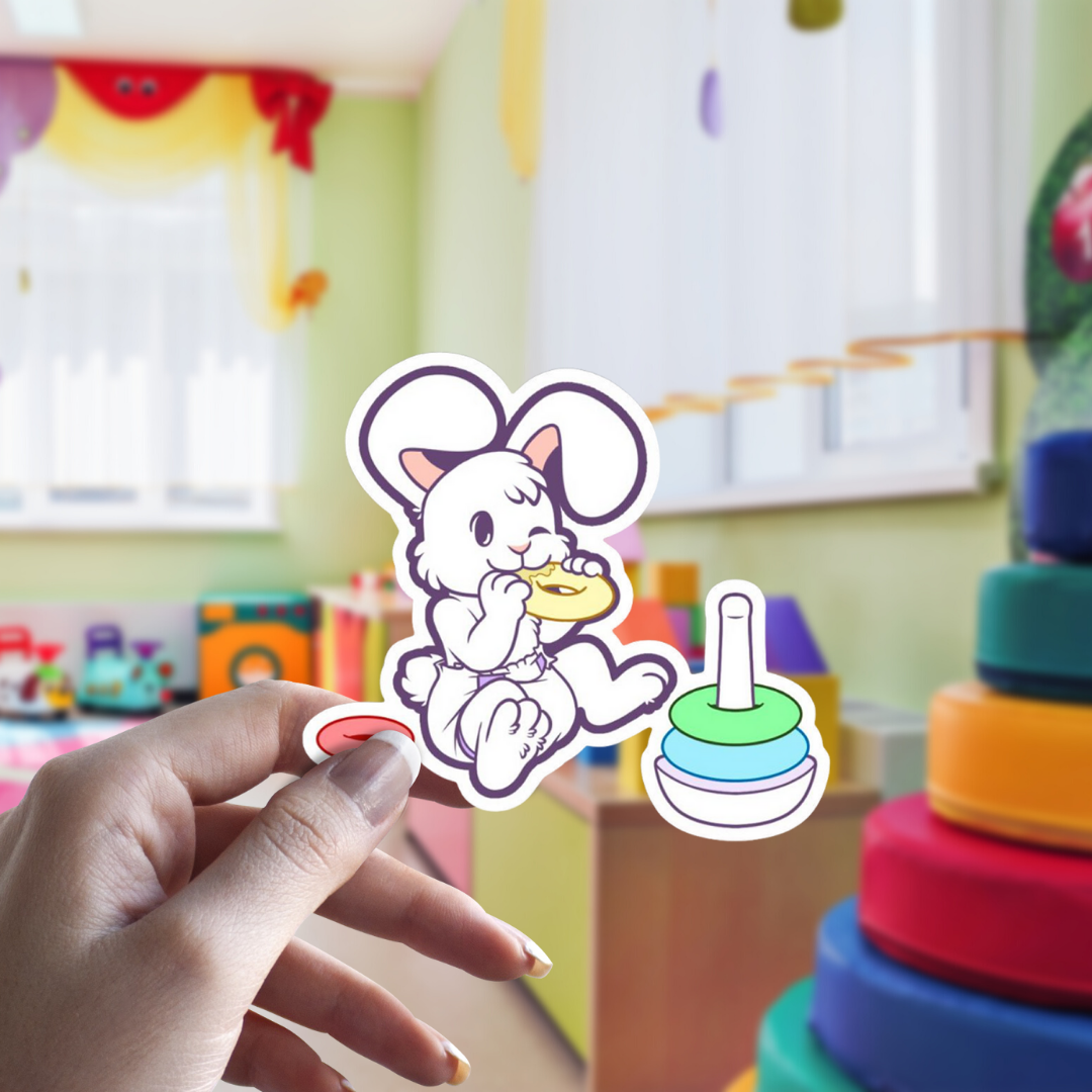 Lil Furs Vinyl Stickers | Bunny wearing diaper eating ring set, held in hand with playroom backgroun | Babyfur | CrinkleKit